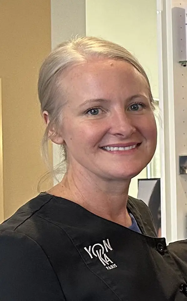 Smiling woman in a black uniform.