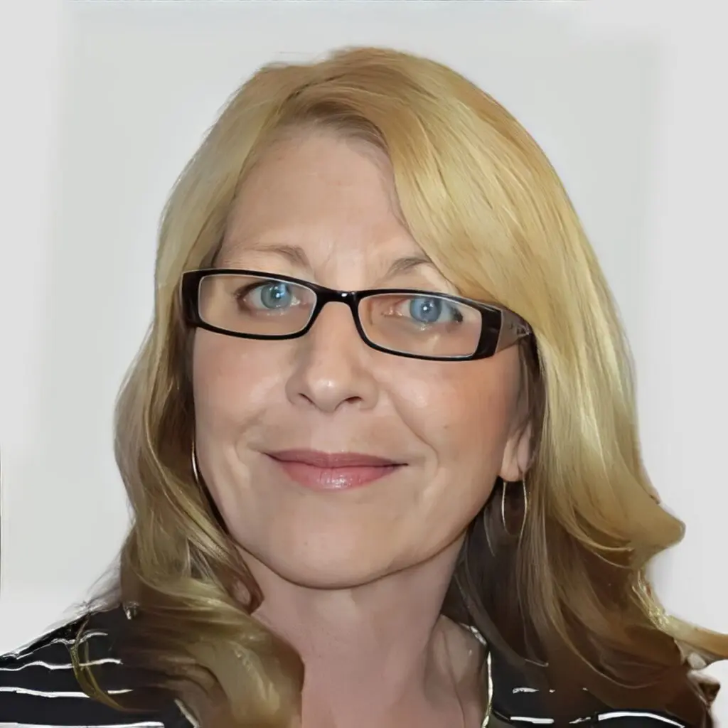 Woman with blonde hair and glasses.