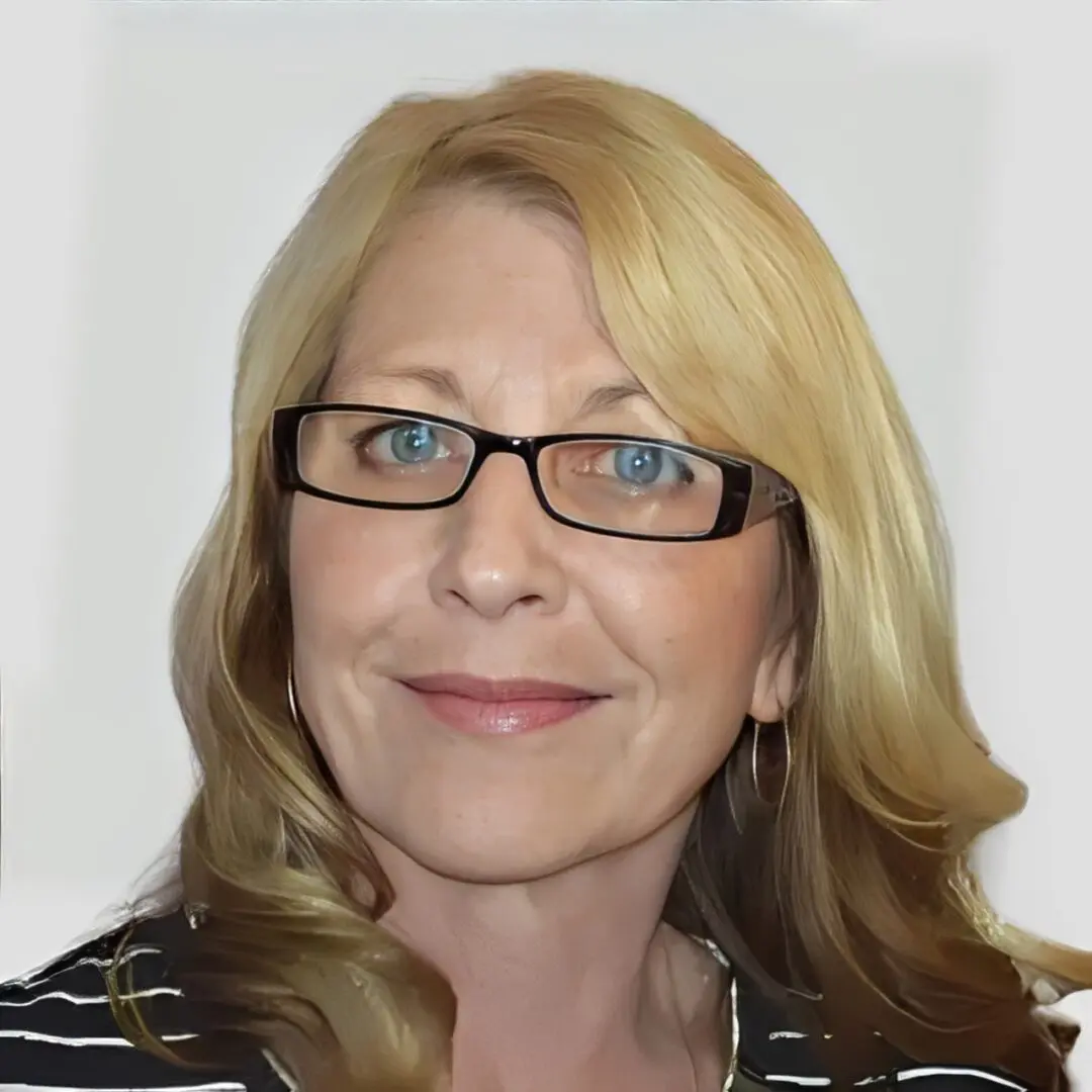 Woman with blonde hair and glasses.