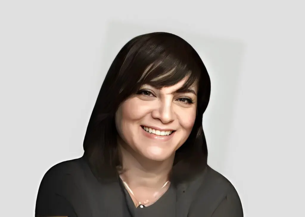 Smiling woman with dark hair and jacket.