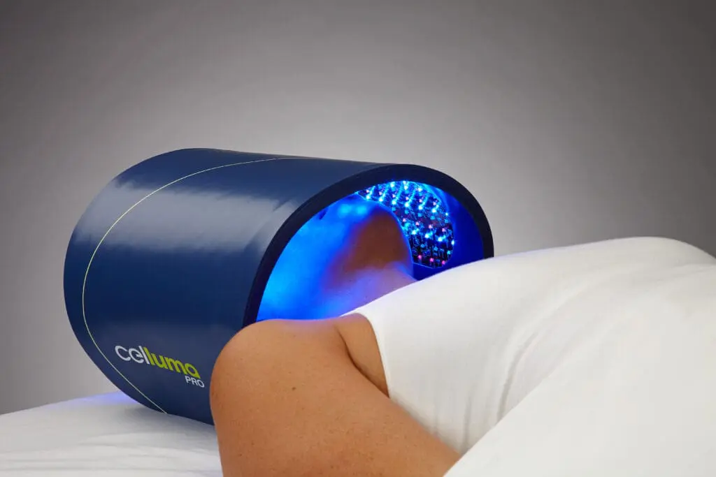 Person using blue light therapy device. Person using blue light therapy device.