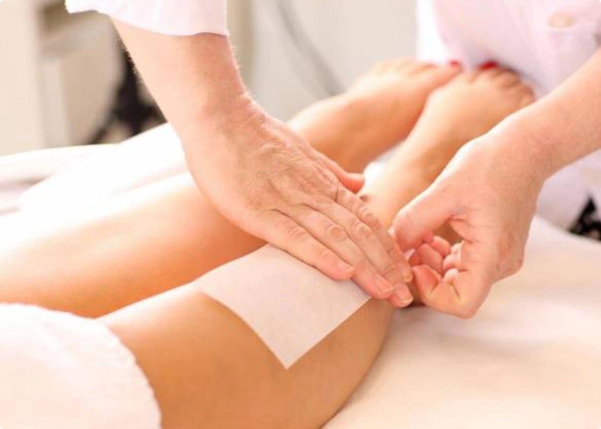 Waxing leg hair removal treatment.