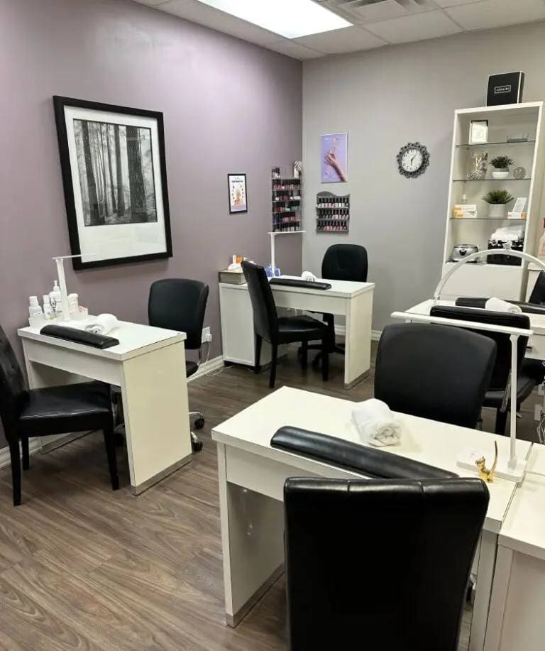 Nail salon with manicure stations and decor.