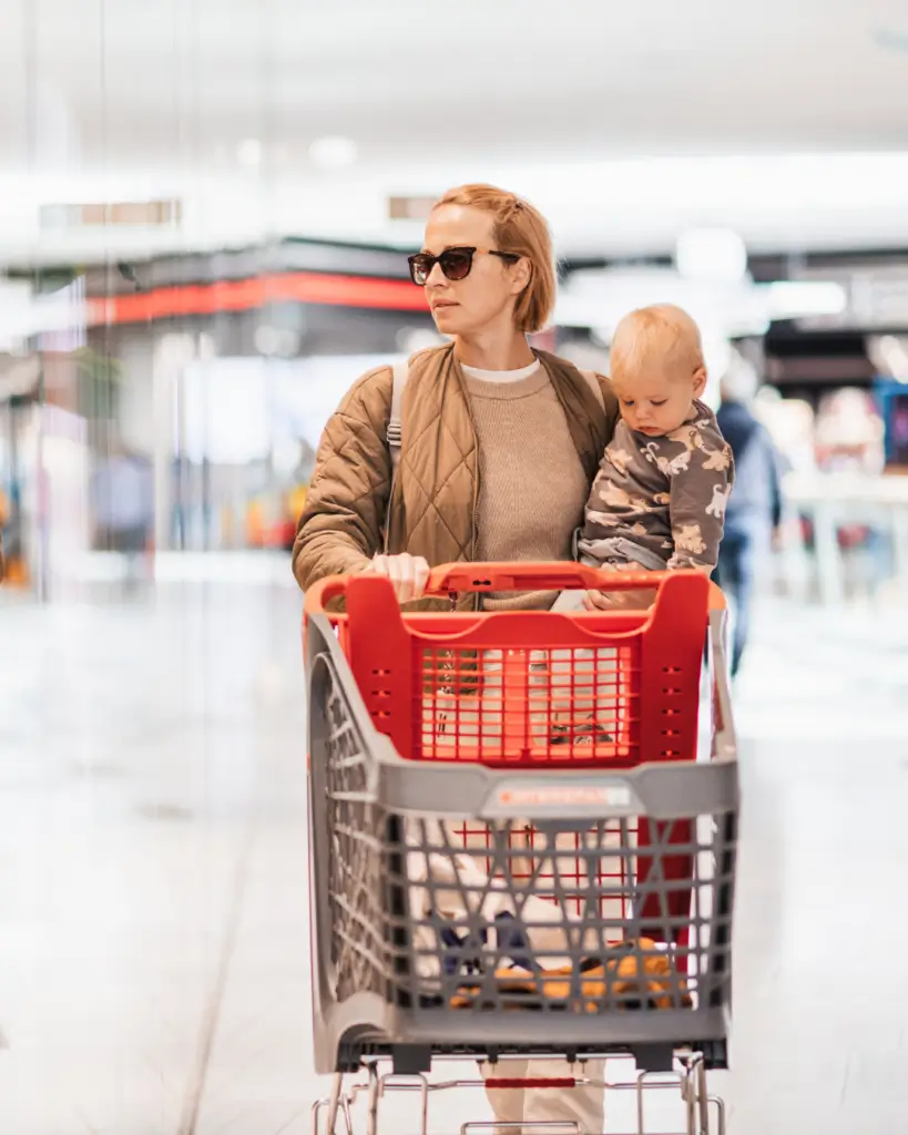 busy mom shopping with young child
